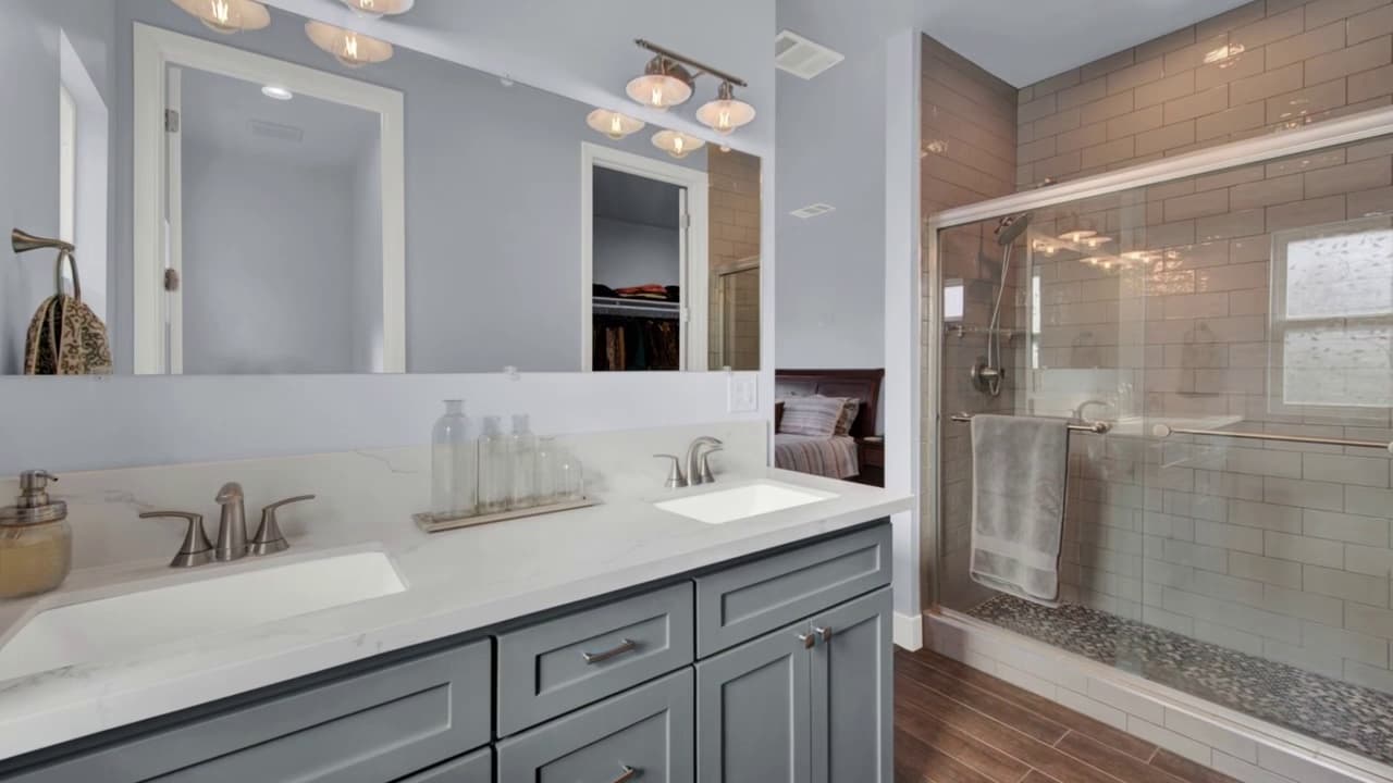 Master bathroom remodel with double vanity and glass walk-in shower in Sacramento — Keystone Building Services