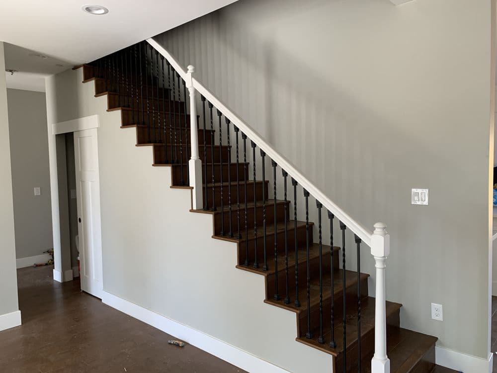 Custom staircase with iron balusters in whole home remodel in Sacramento — Keystone Building Services